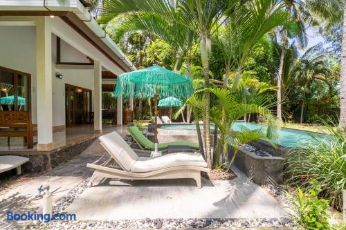 Pool Patio Area with Sun Loungers and Umbrellas